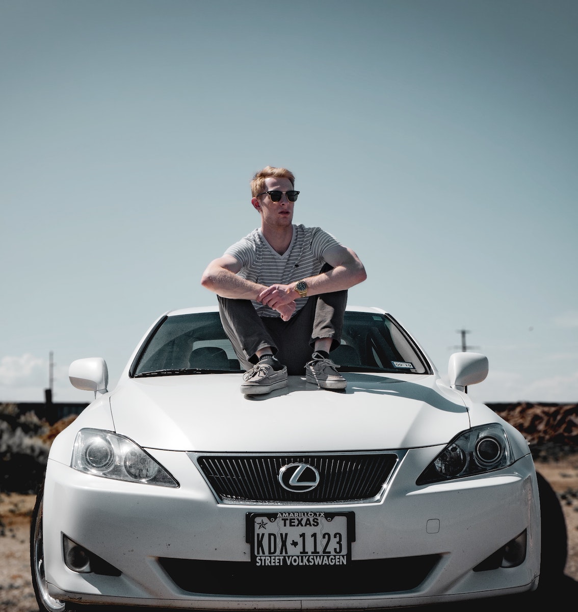 Man Sitting on Lexus Vehicle