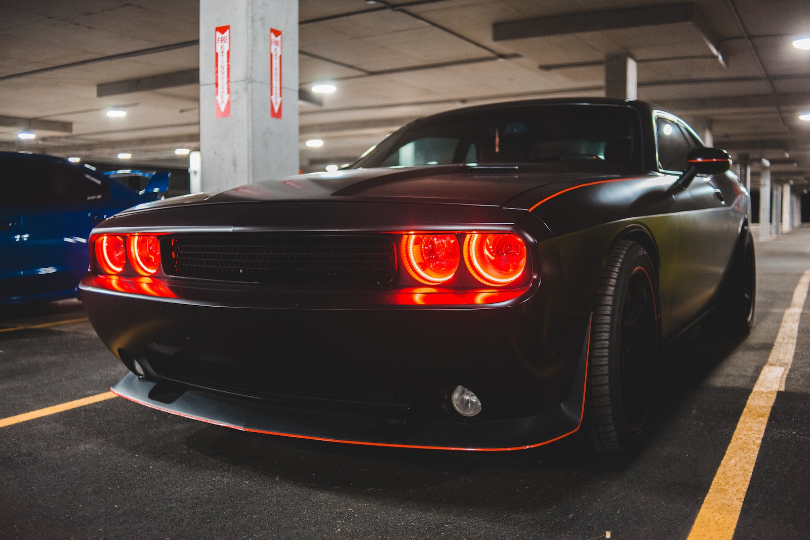 Stylish automobile with glowing headlights on parking